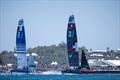 Switzerland SailGP Team helmed by Nathan Outteridge ahead of France SailGP Team helmed by Quentin Delapierre as spectators watch from the grandstand in the Race Stadium on Race Day 1 of the Apex Group Bermuda Sail Grand Prix in Bermuda