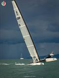 A Class Cat Worlds at Punta Ala - GBR Classic A-Cat sailor and National Champ, Hugh MacGregor GBR 18, having fun as he runs from the storm © Gordon Upton / www.guppypix.com