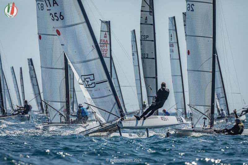 The Classic fleet round the top spreader on the first lap, race 3  - A Class Cat Worlds at Punta Ala day 2 photo copyright Gordon Upton / www.guppypix.com taken at Centro Velico Punta Ala and featuring the A Class Catamaran class