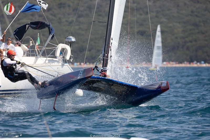 Giorgio Lais, hotdogging the finish - A Class Cat Worlds at Punta Ala day 2 - photo © Gordon Upton / www.guppypix.com