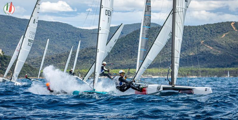 A Class Cat Worlds at Punta Ala - The top mark on the Open course, first lap is always good for potential crowd-pleasing moments. Here Thomas Paasch, DEN 1 gets a teabagging - photo © Gordon Upton / www.guppypix.com