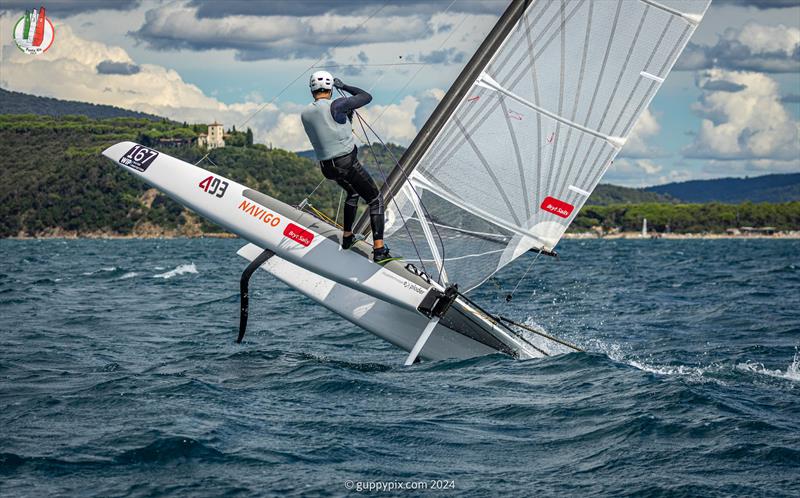 A Class Cat Worlds at Punta Ala - Kuba celebrates in his traditional style photo copyright Gordon Upton / www.guppypix.com taken at Centro Velico Punta Ala and featuring the A Class Catamaran class