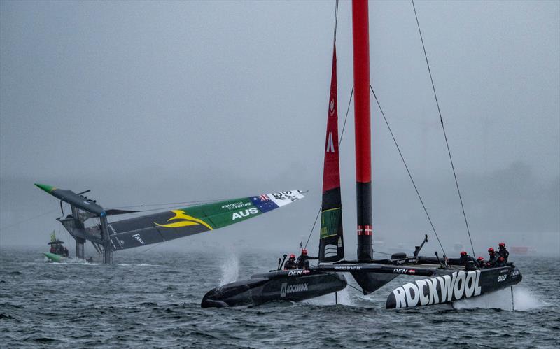 ROCKWOOL Denmark SailGP Team helmed by Nicolai Sehested sail past as the Australia SailGP Team F50 catamaran is towed upright after capsizing during the second race on Race Day 2 of the ROCKWOOL Canada Sail Grand Prix in Halifax, Canada - photo © Ricardo Pinto for SailGP