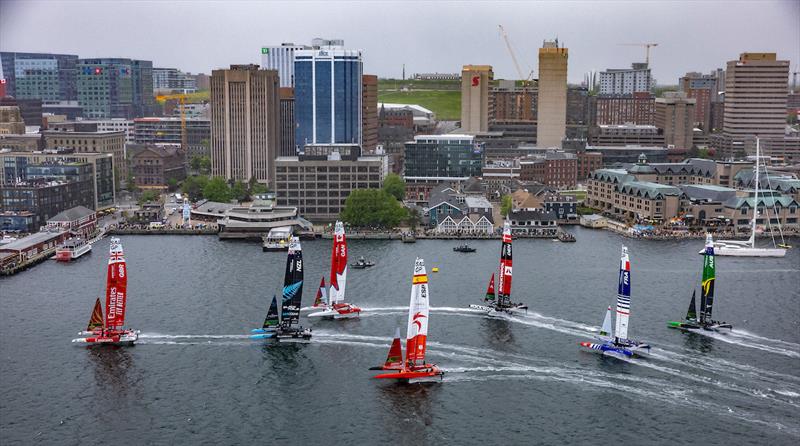 The fleet race towards the skyline in the rain with Emirates Great Britain SailGP Team helmed by Giles Scott leading ahead of Spain SailGP Team, New Zealand SailGP Team, and Canada SailGP Team, on Race Day 2 of the ROCKWOOL Canada Sail Grand Prix - photo © Simon Bruty for SailGP