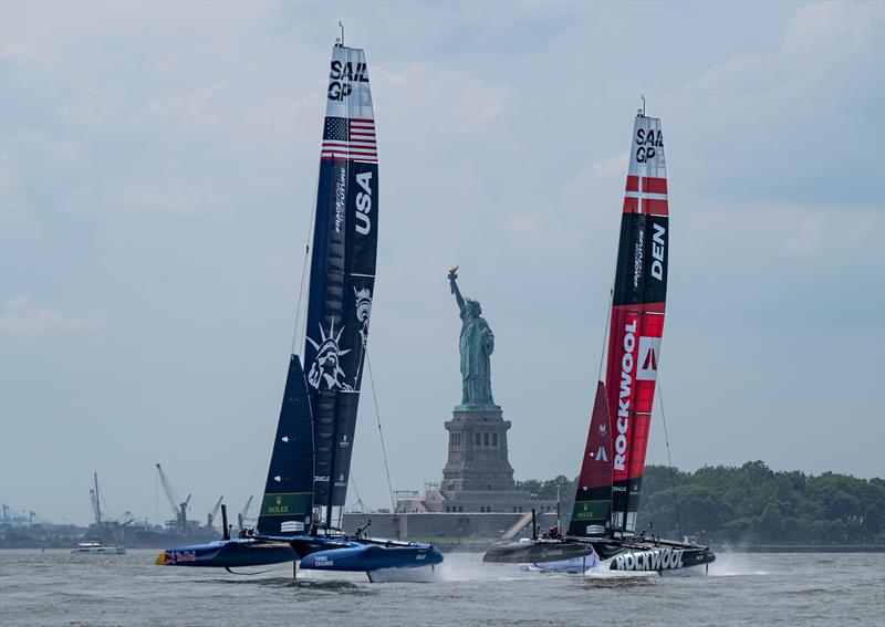 USA SailGP Team leads Rockwool Denmark SailGP Team  as they pass the Statue of Liberty Race Day 2 of the Mubadala New York Sail Grand Prix - June 23, 2024  - photo © Ricardo Pinto/SailGP