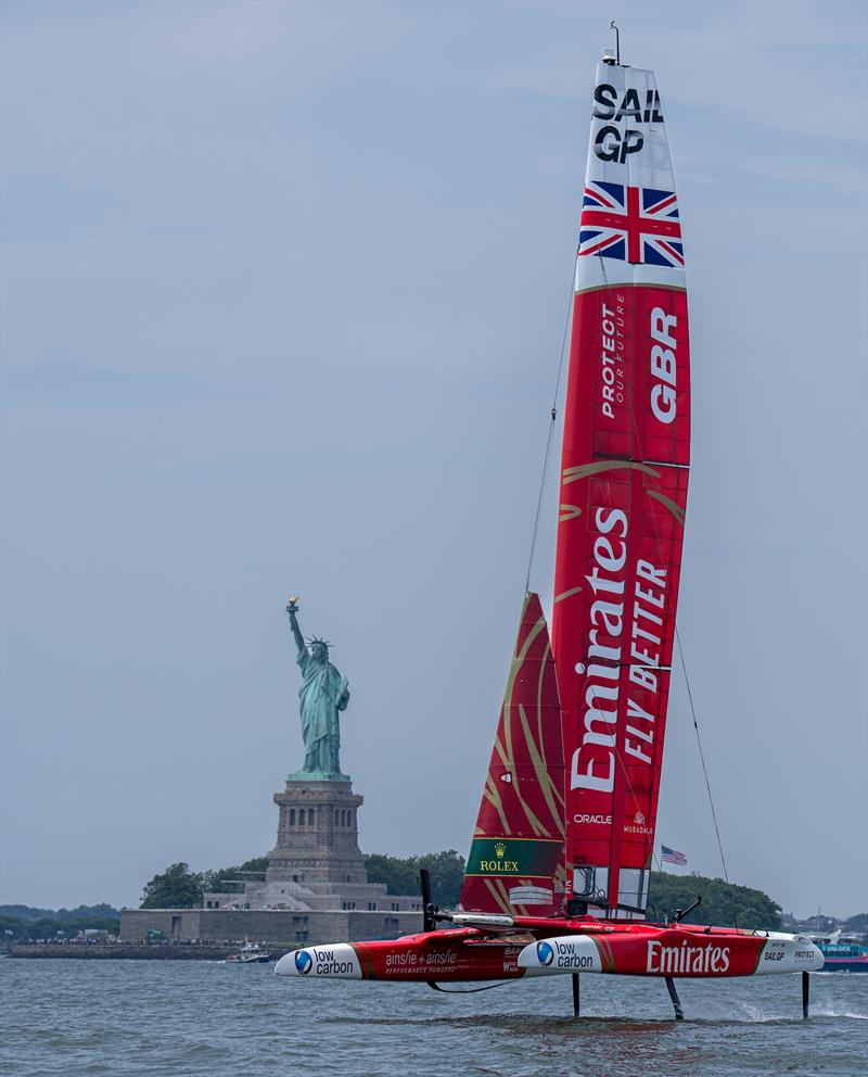 Emirates Great Britain SailGP Team helmed by Giles Scott passes the Statue of Liberty on Race Day 2 of the Mubadala New York Sail Grand Prix in New York, USA photo copyright Bob Martin for SailGP taken at  and featuring the F50 class