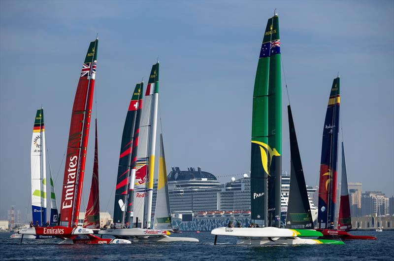 The fleet cross the start line led by Australia SailGP Team and Spain SailGP Team on Race Day 1 of the Emirates Dubai Sail Grand Prix presented by P&O Marinas in Dubai, UAE photo copyright Felix Diemer for SailGP taken at  and featuring the F50 class