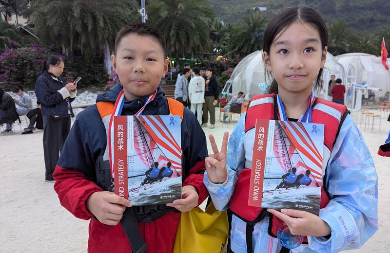 Kids with their Wind Strategy books at the Shuifu Jinshajiang River Regatta - photo © Mark Jardine