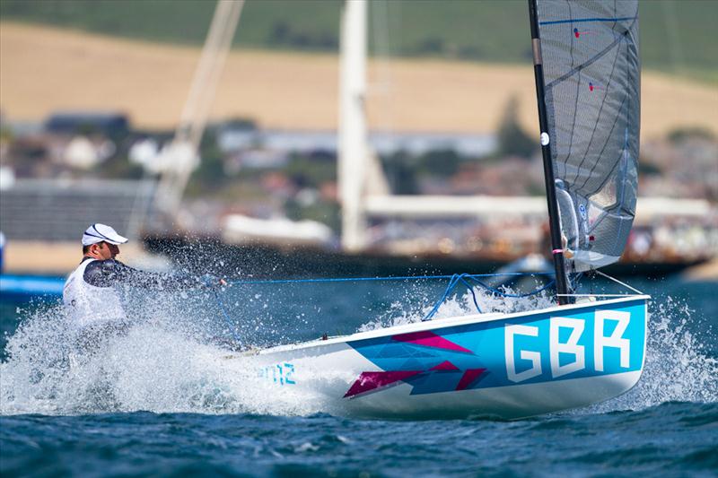 Finns on day one of the London 2012 Olympic Sailing Competition photo copyright Tom Gruitt / www.tom-gruitt.co.uk taken at Weymouth & Portland Sailing Academy and featuring the Finn class