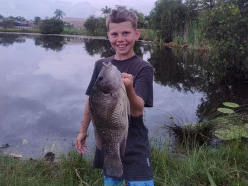 Kade Whittle hauled in this massive tilapia from a local lake. The biggest we've ever seen - photo © Fisho's Tackle World