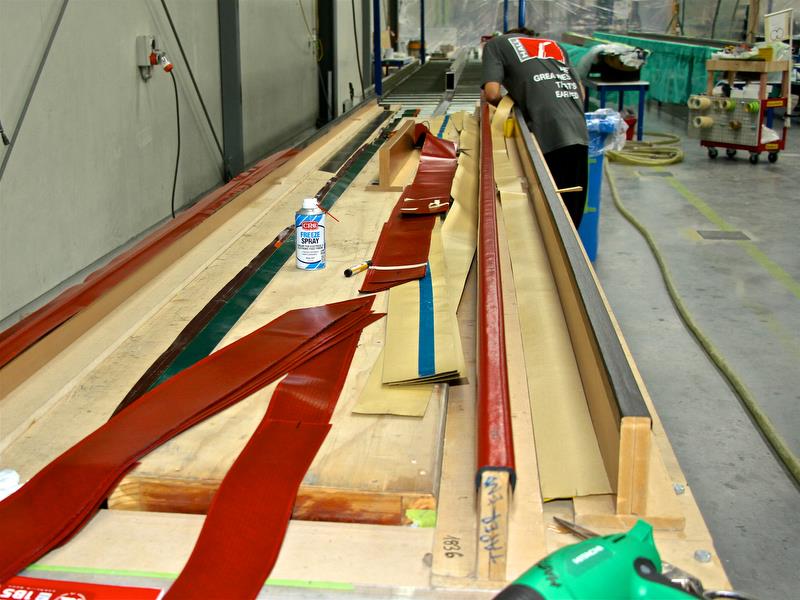 Hall Spars - Battens are laid up on wooden formers before being inserted in the mould. The outer strip of carbon on the flex batten runs for its full length - photo © Richard Gladwell