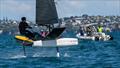 Jake Pye crosses the finish line to win the Final Race watched by the Coutts support team   - Day 5 - 2024 PredictWind Moth Worlds - Manly Sailing Club. January 9, 2025 © Richard Gladwell - Sail-World.com/nz