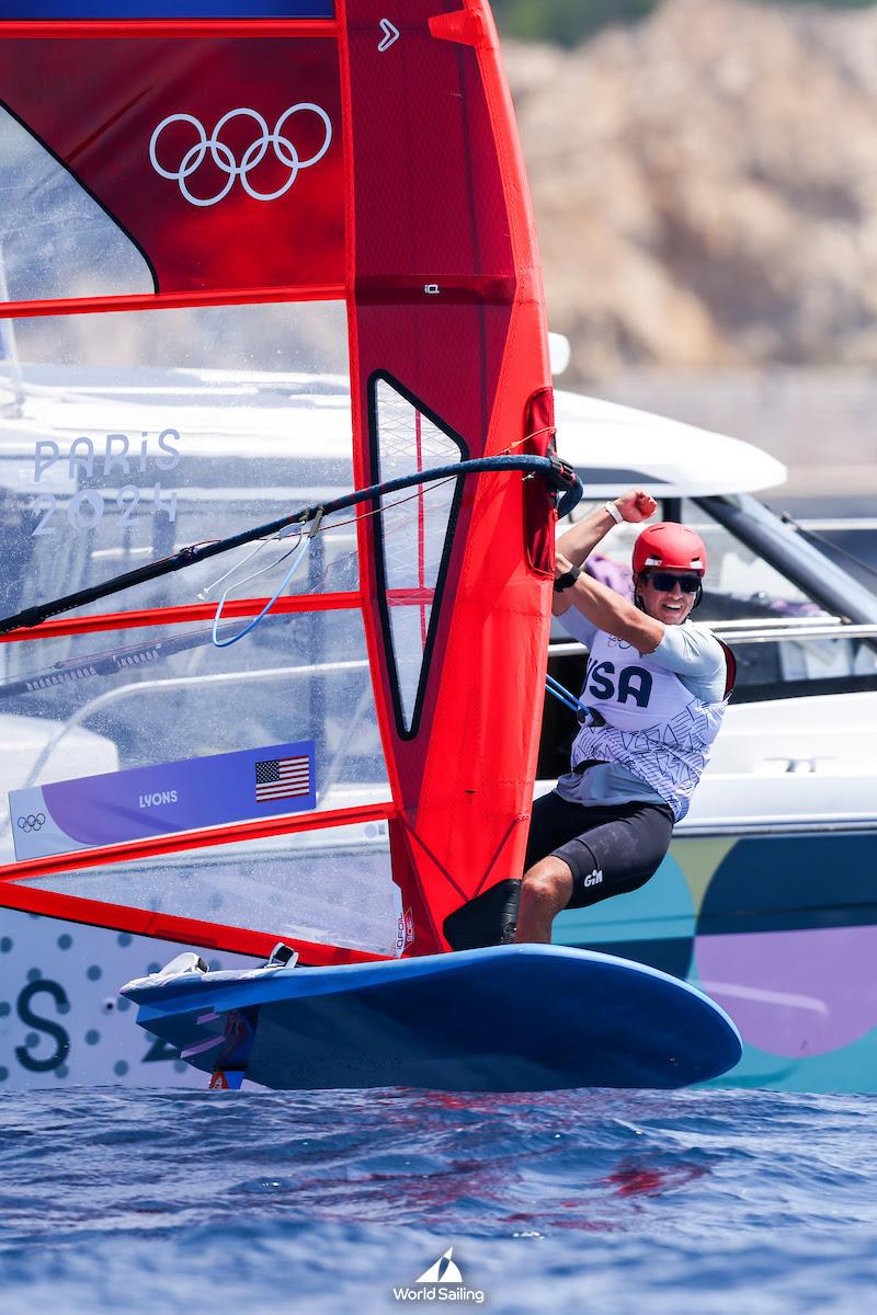 Men's Windsurfer Noah Lyons (Clearwater, FL) cheers as he crosses the finish line in first in the day's opening race photo copyright World Sailing / Lloyd Images taken at  and featuring the iQFoil class