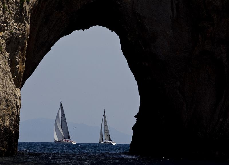 Competitors pass by the Faraglioni rock formations off the south-east coast of Capri during the Rolex Volcano Race 2010 photo copyright Carlo Borlenghi / Rolex taken at Yacht Club Capri and featuring the IRC class