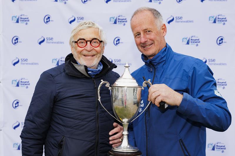 Teasing Machine skipper Eric de Turckheim (left) competing for the Royal Ocean Racing Club and overall winner of the SSE Renewables Round Ireland Race 2024 pictured with Race Director Kyran O'Grady of Wicklow Sailing Club photo copyright David Branigan / Oceansport taken at Wicklow Sailing Club and featuring the IRC class