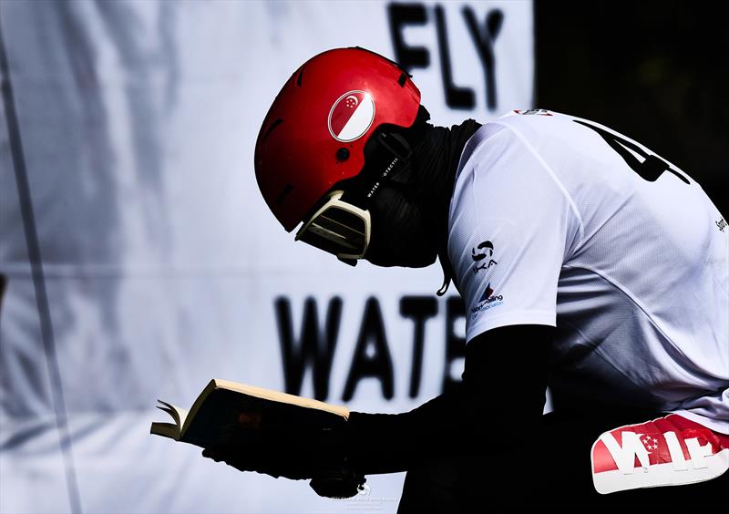 Maeder with his nose in a book - 2024 KiteFoil World Series Austria - photo © IKA media/ Robert Hajduk