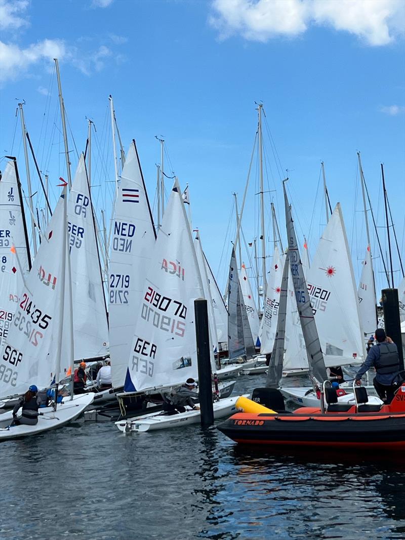 An on-water traffic jam on Saturday during Kieler Woche when five fleets are released to launch at once photo copyright Martin Pascoe taken at Kieler Yacht Club and featuring the ILCA 6 class