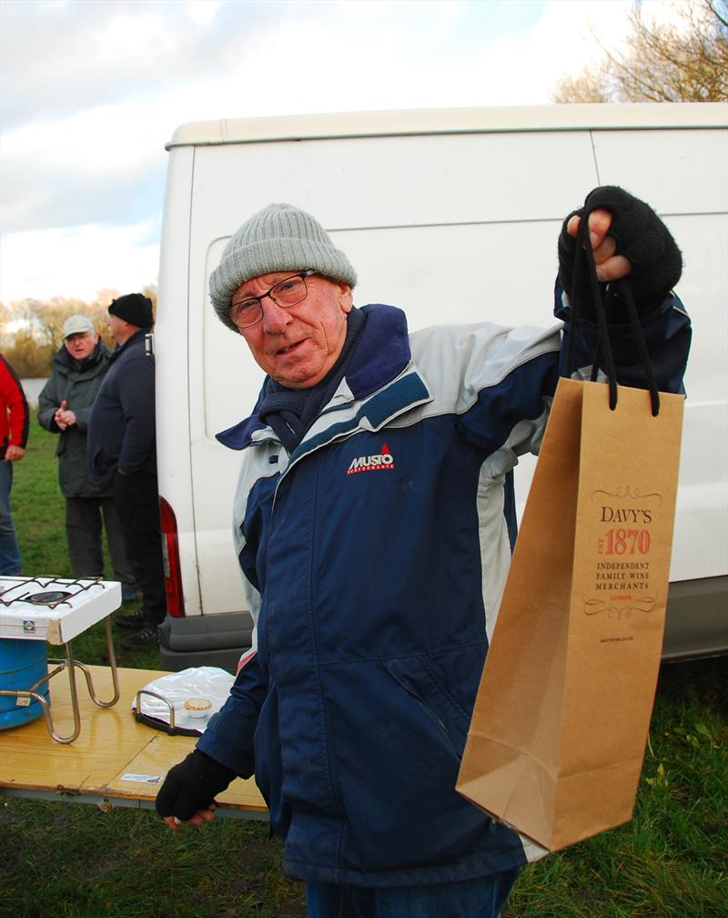 Brass Monkey Christmas race at Abbey Meads - hard-working Race Officer Martin Crysell receiving his reward photo copyright Roger Stollery taken at Guildford Model Yacht Club and featuring the Marblehead class