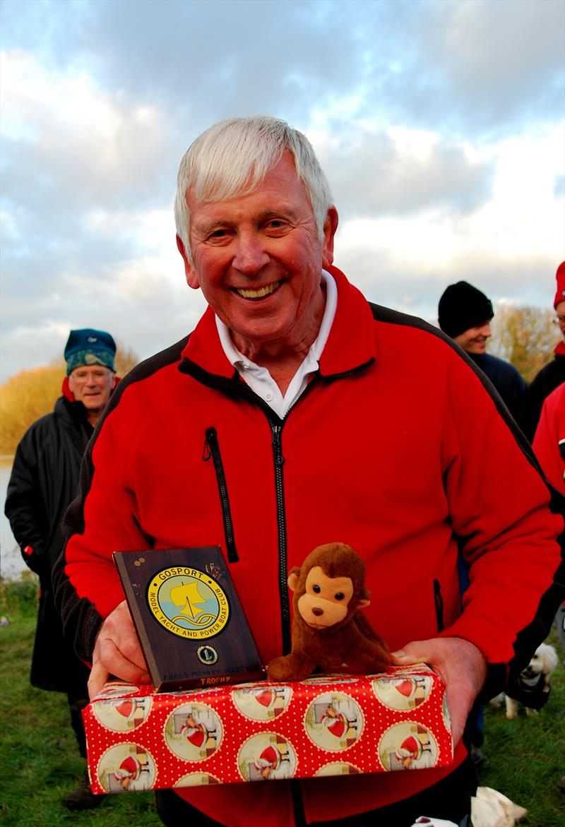 Brass Monkey Christmas race at Abbey Meads - a delighted Phil Holliday collecting his prize and the Brass Monkey photo copyright Roger Stollery taken at Guildford Model Yacht Club and featuring the Marblehead class