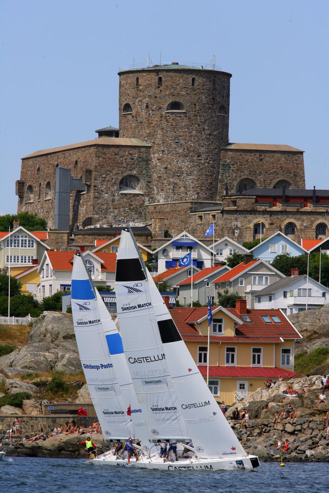 Russell Coutts is tight to leeward of Dean Barker in Flight 4, with Marstrand’s Carlsten Fortress dominating the backdrop on Day 3 of the Swedish Match Cup photo copyright Swedish Match Tour / Guido Cantini taken at  and featuring the Match Racing class