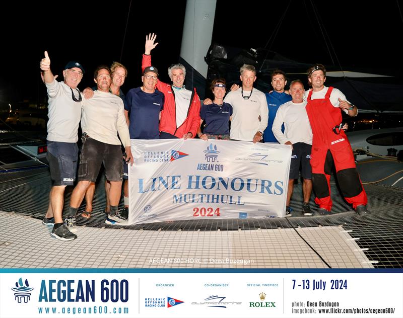 The line honours-winning Zoulou crew of Erik Maris (centre with arm raised), including French multihull legend Loick Peyron (far left) and Britain Ned Collier Wakefield (far right) photo copyright Deea Buzdugan taken at  and featuring the MOD70 class