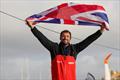 Vulnerable skipper Sam Goodchild (GBR) is photographed with a UK flag after taking 9th place in the Vendée Globe