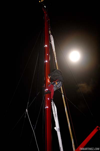 Derek Hatfield (Algimouss Spirit of Canada) is working hard to repair his mast track photo copyright Th. Martinez / Sea&Co / www.thmartinez.com taken at  and featuring the IMOCA class