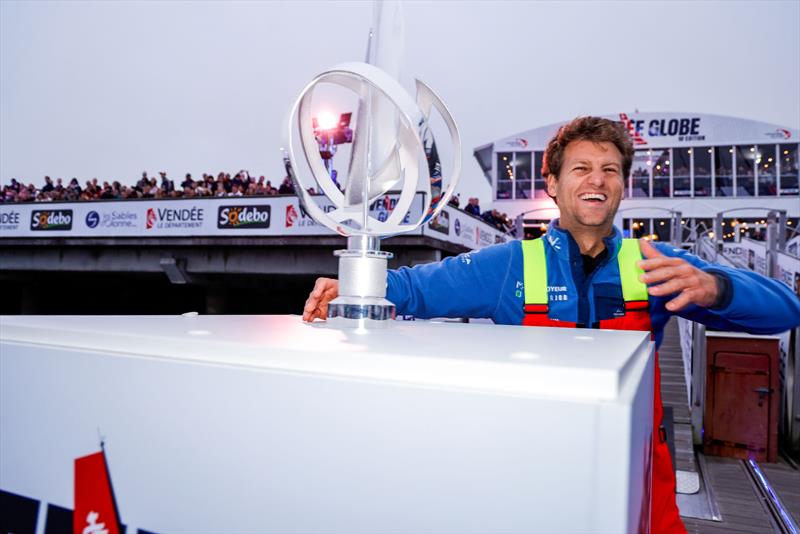 10th Vendée Globe departure - Benjamin Ferré smiling as he passes the trophy - photo © Anne Beaugé / Alea