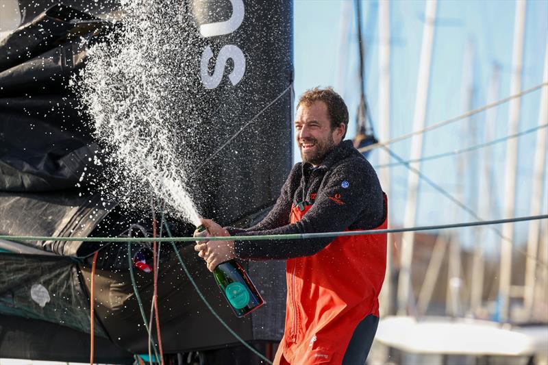 Vulnerable skipper Sam Goodchild (GBR) is celebrating with champagne after taking 9th place in the Vendée Globe - photo © Jean-Marie Liot / Alea