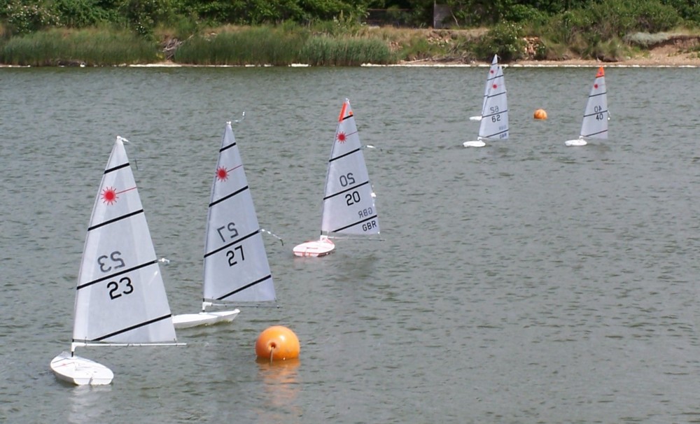 The fleet sail downwind at the Snettisham Beach RC Laser open photo copyright Kevin Appleton taken at Snettisham Beach Sailing Club and featuring the RC Laser class