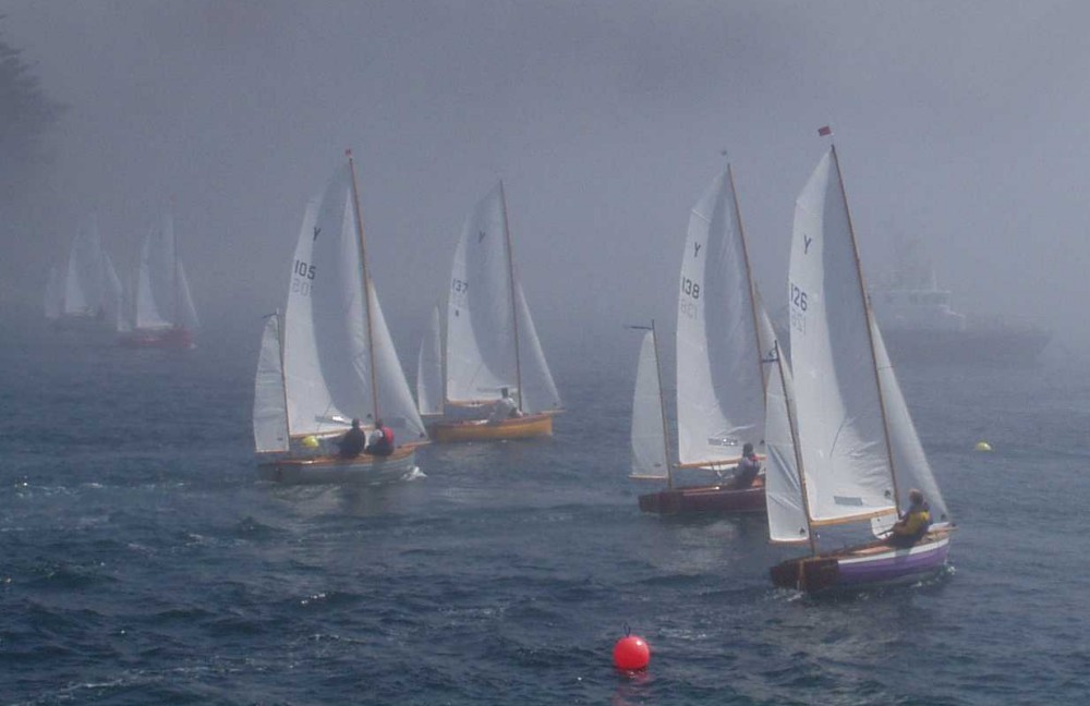 The red fleet emerge from the mist at the Salcombe Yawl open photo copyright John Murrell taken at Salcombe Yacht Club and featuring the Salcombe Yawl class