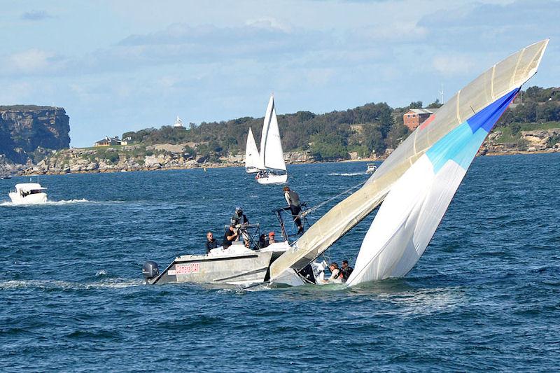 Thomas Quigley catches Team Daly's collision with a camera boat during race 2 of the 2013 JJ Giltinan Championship photo copyright Thomas Quigley taken at  and featuring the 18ft Skiff class