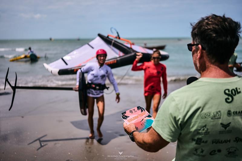 Kylie Belloeuvre steps on to the beach to receive her Golden Ticket - 2024 WingFoil Racing World Cup Brazil - photo © IWSA media/ Robert Hajduk